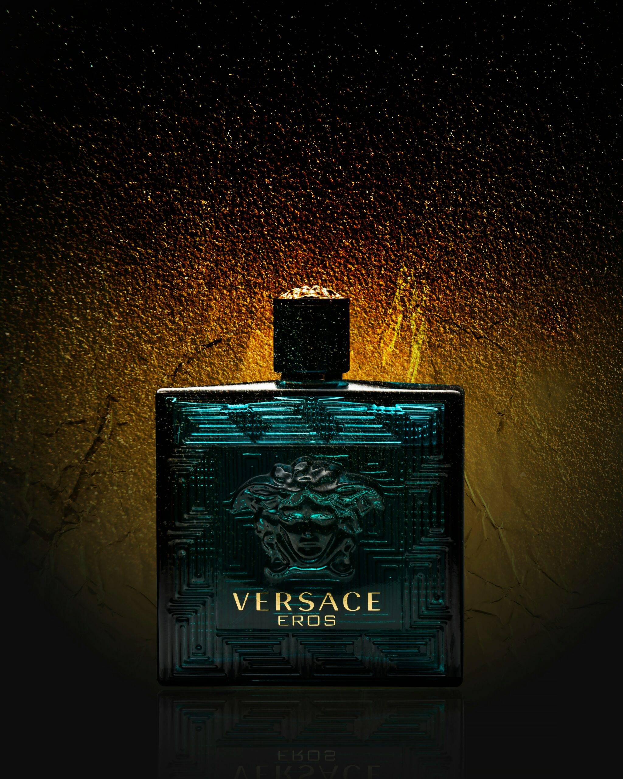 a product photography image of a versace eros perfume bottle on a gold decorated background