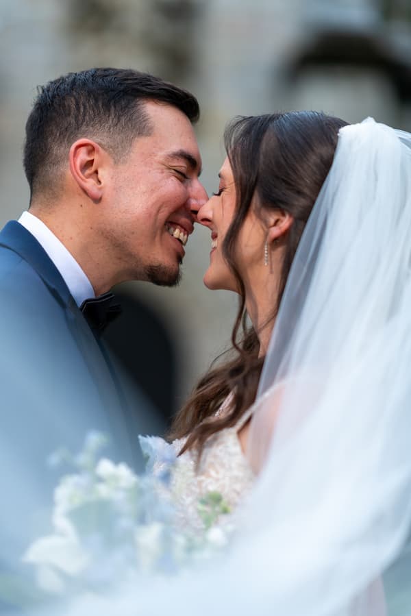 a close-up of a bride and groom sharing an intimate moment during their wedding day.