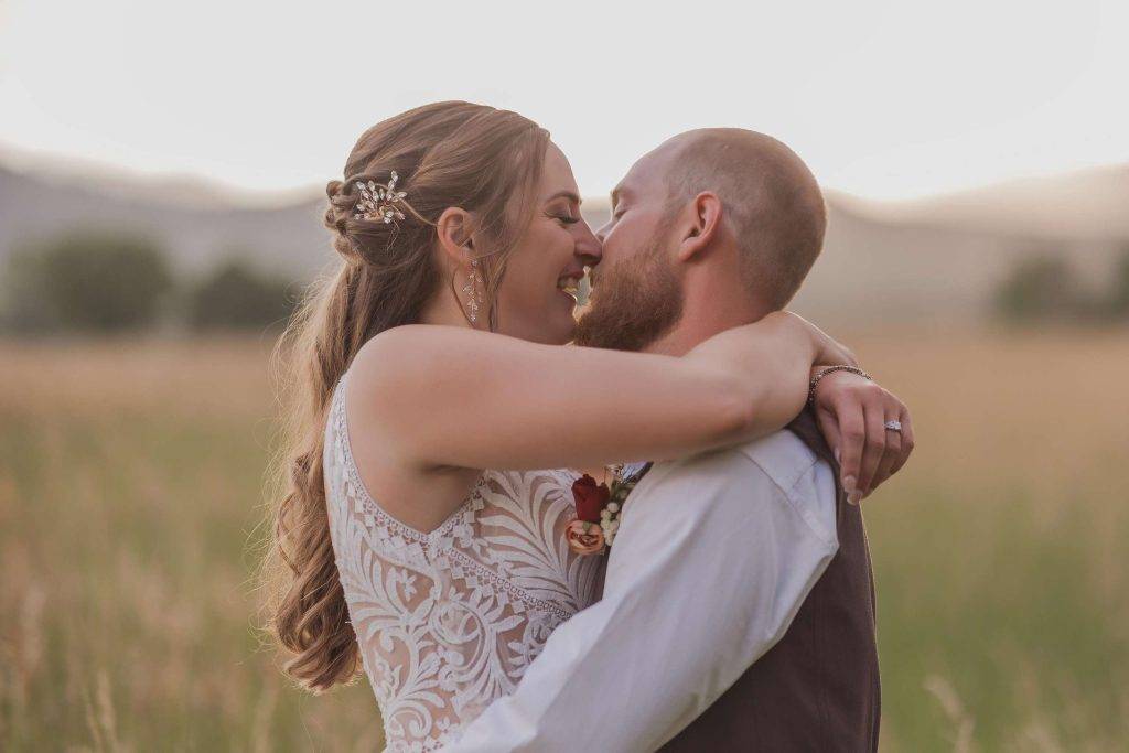 candid wedding photography image of bride and groom kissing