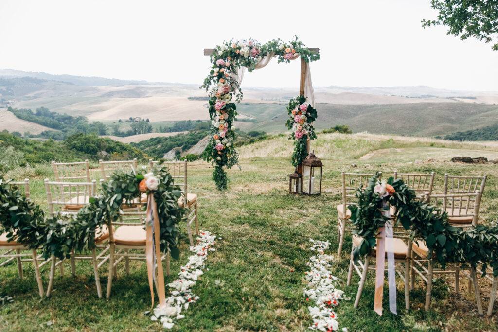 Wedding decoration. Green eucalyptus, oranges and pink flowers decorate wedding altar in Steamboat Springs, Colorado.