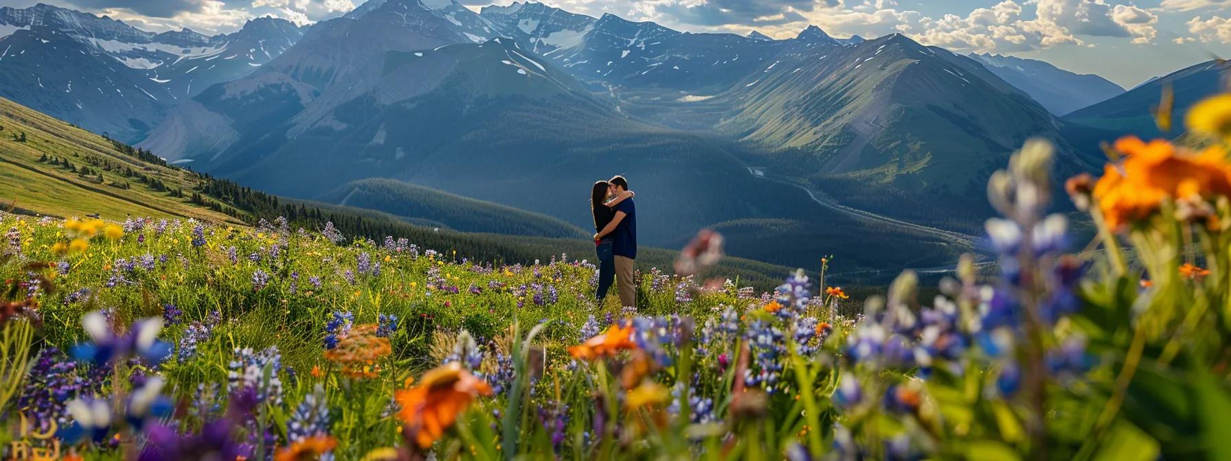 a picturesque mountain vista framing a couple in an embrace amidst a field of colorful wildflowers for an engagement photo.