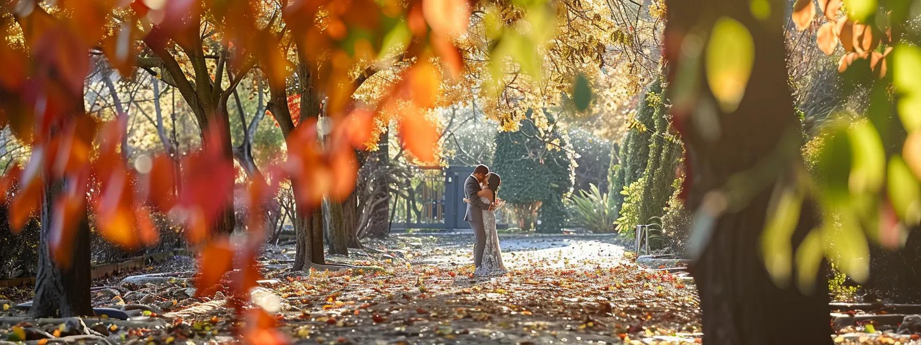 a bride and groom sharing a tender embrace in a picturesque outdoor setting, surrounded by colorful autumn foliage.