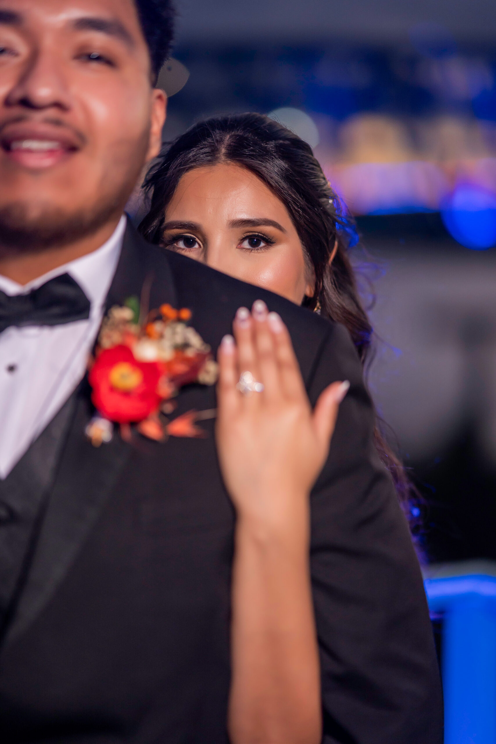 A bride posing behind a groom's shoulder in Jacksonville, Florida